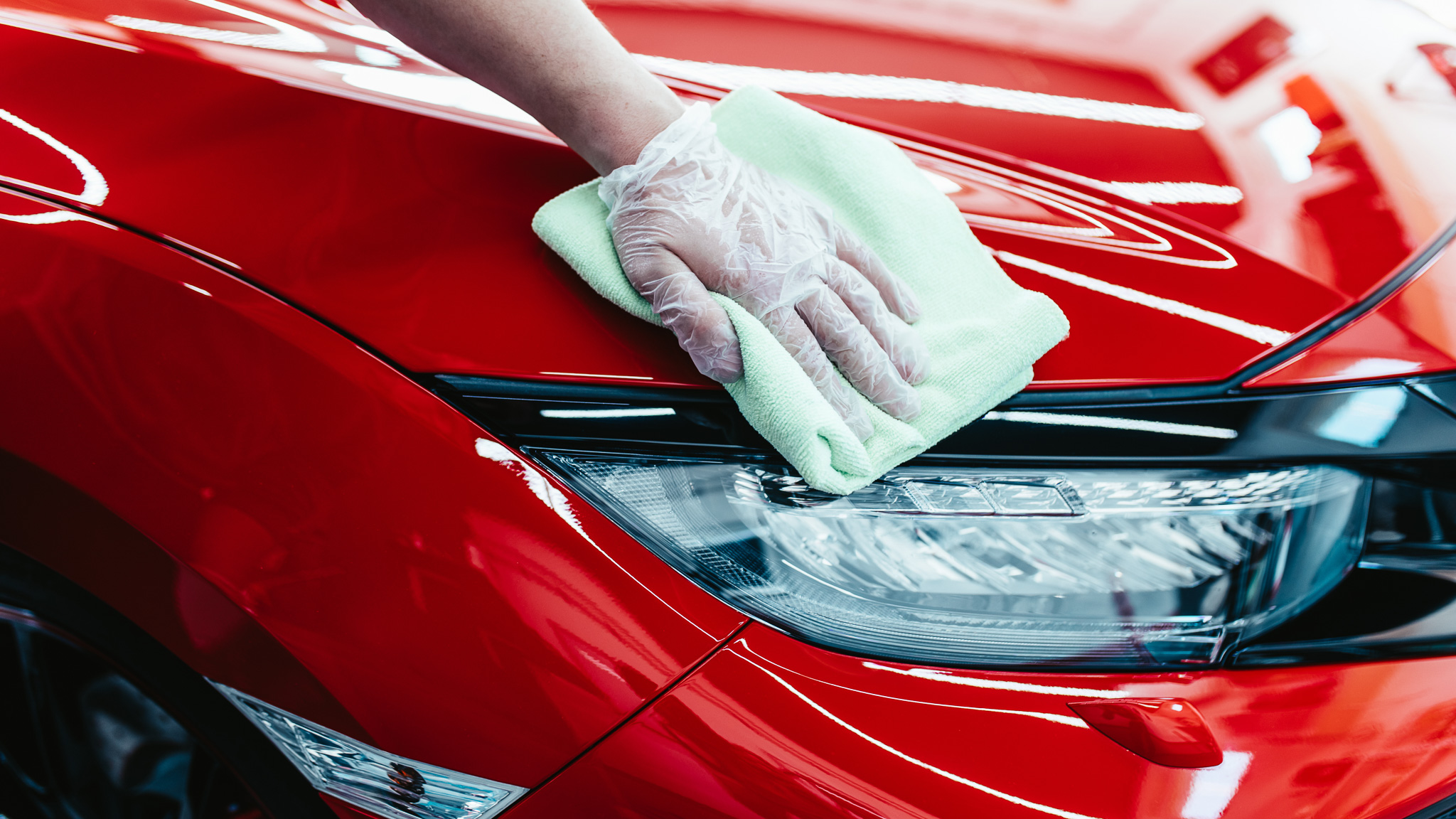 A man cleaning car with cloth, car detailing (or valeting) conce
