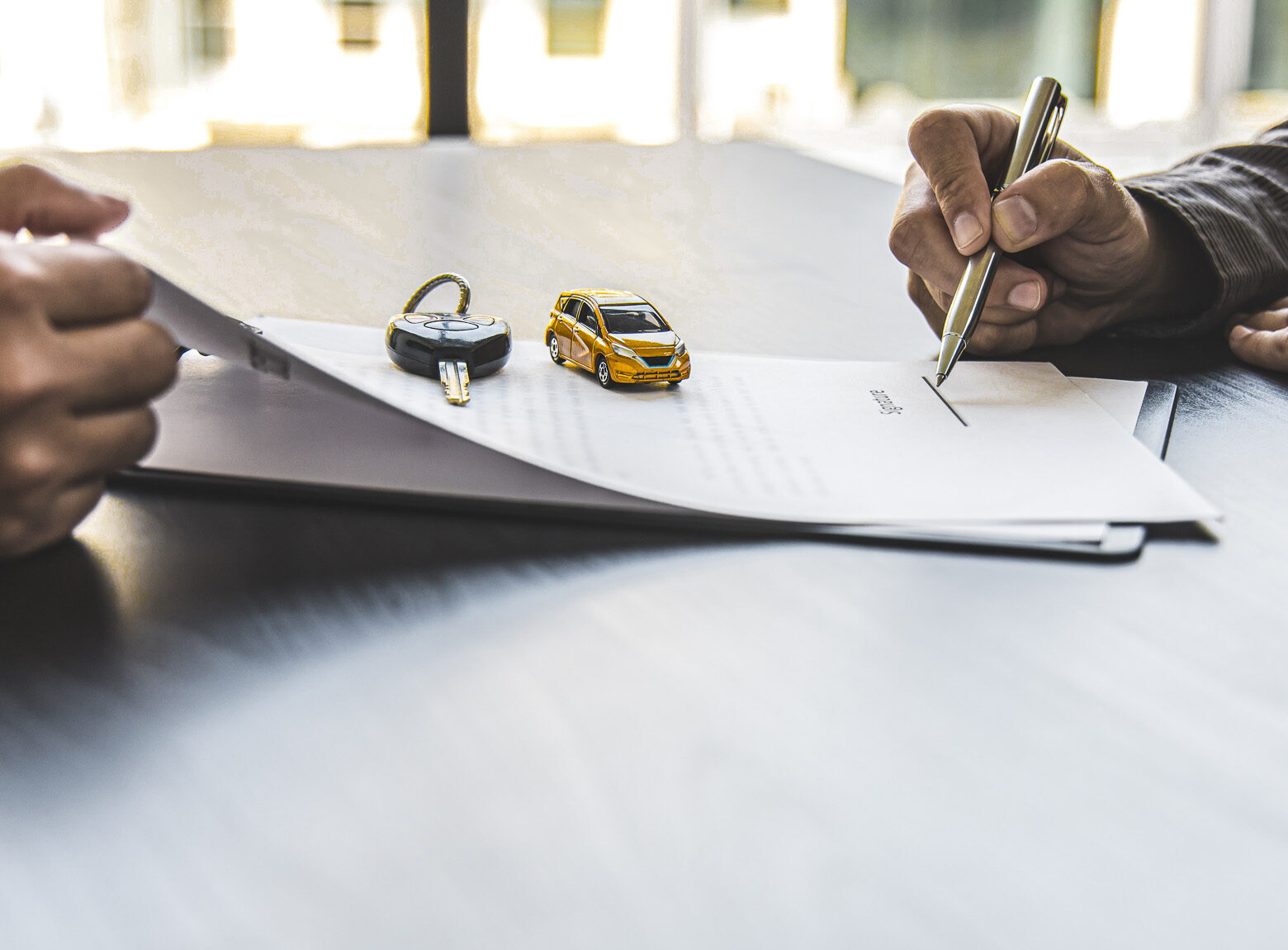 Female attendant handed over the rental car key to the customer